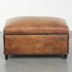 Characterful sheepskin footstool/ottoman finished with black piping