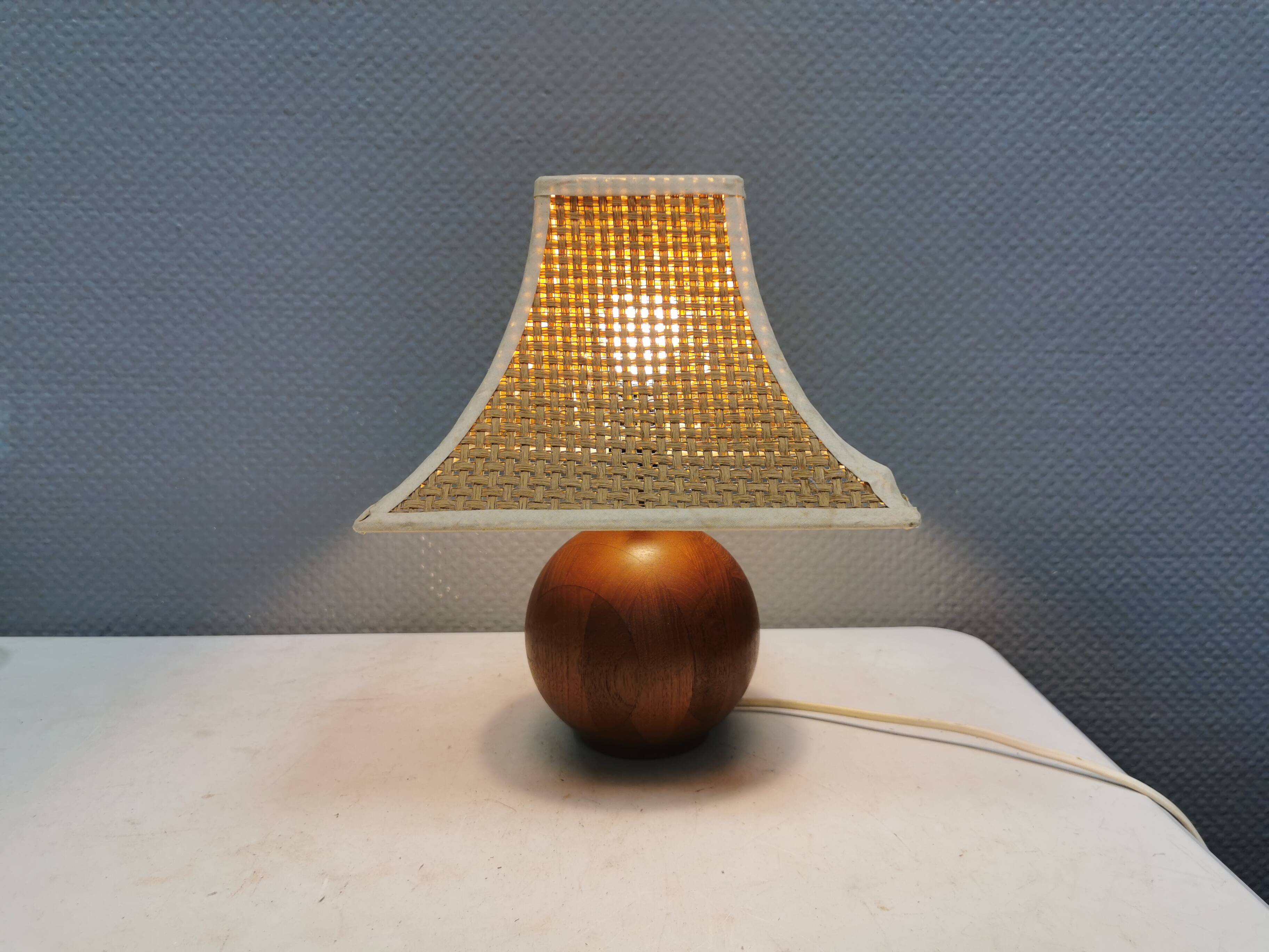 Very rare table lamp in turned teak wood with original braided shade. 1970s