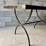 Table made of wrought iron and cement