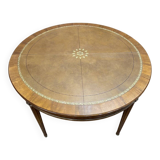 Round dining table with leather top in Louis XVI style.
