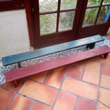 Low bench rests feet in patinated wood