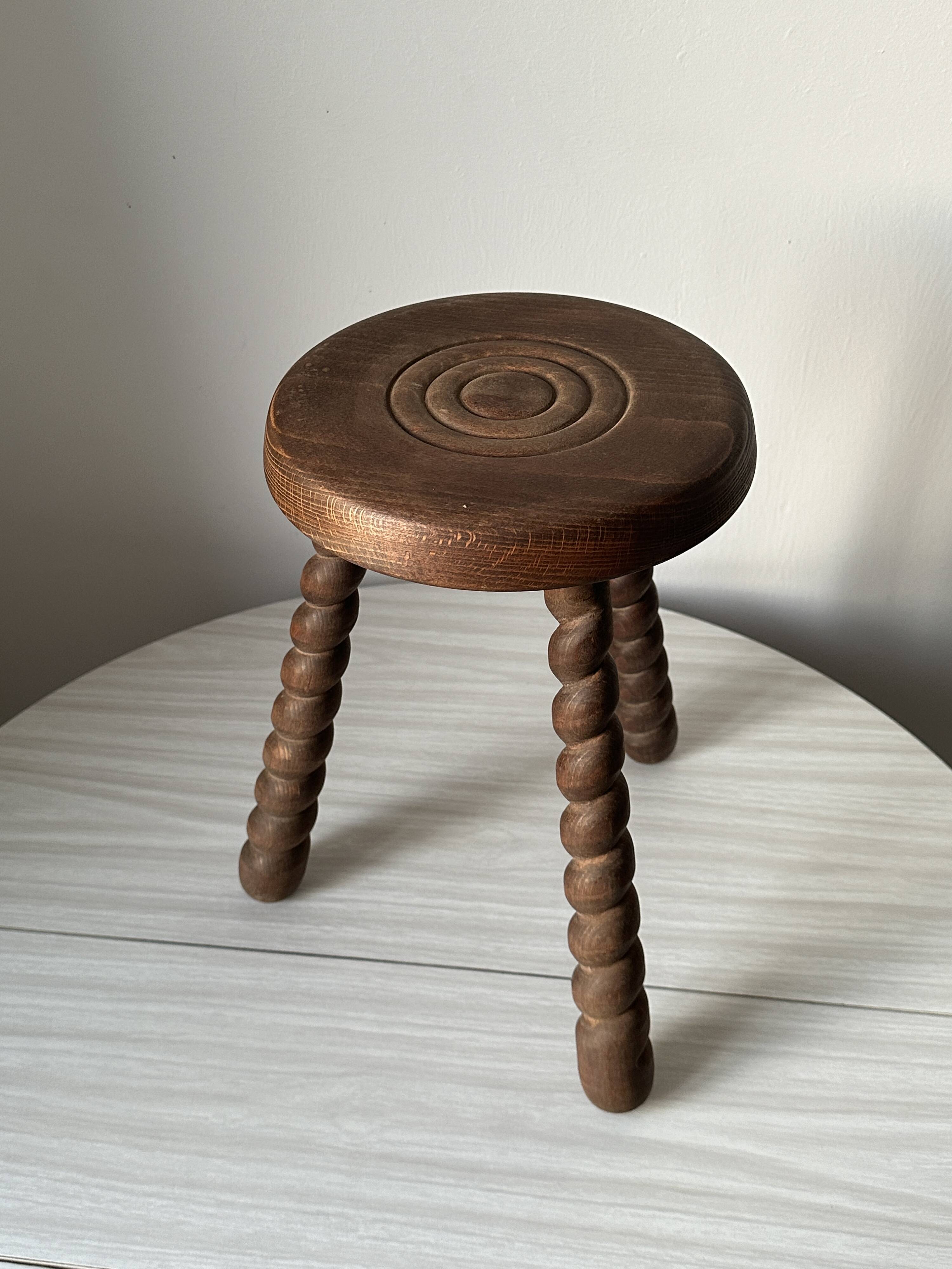 Wooden stool with three twisted legs