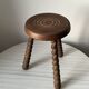 Wooden stool with three twisted legs