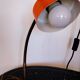 Orange metal lamp from the 60s and 70s.