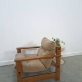 Brown-grey armchair with an oak frame.
