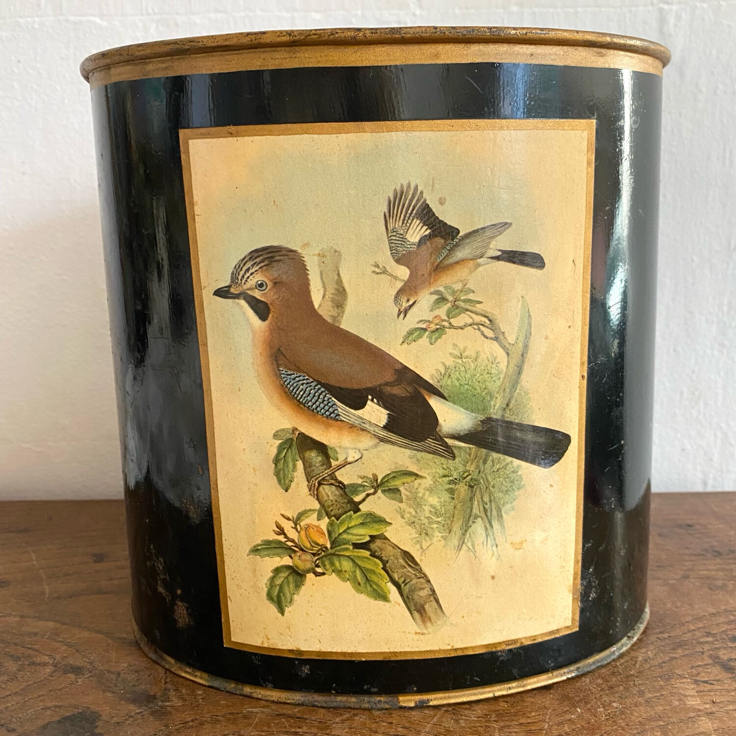 Metal wastebasket with bird decoration