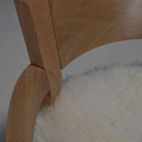 Set of two solid oak and off-white sheepskin chairs, Switzerland, 1970s