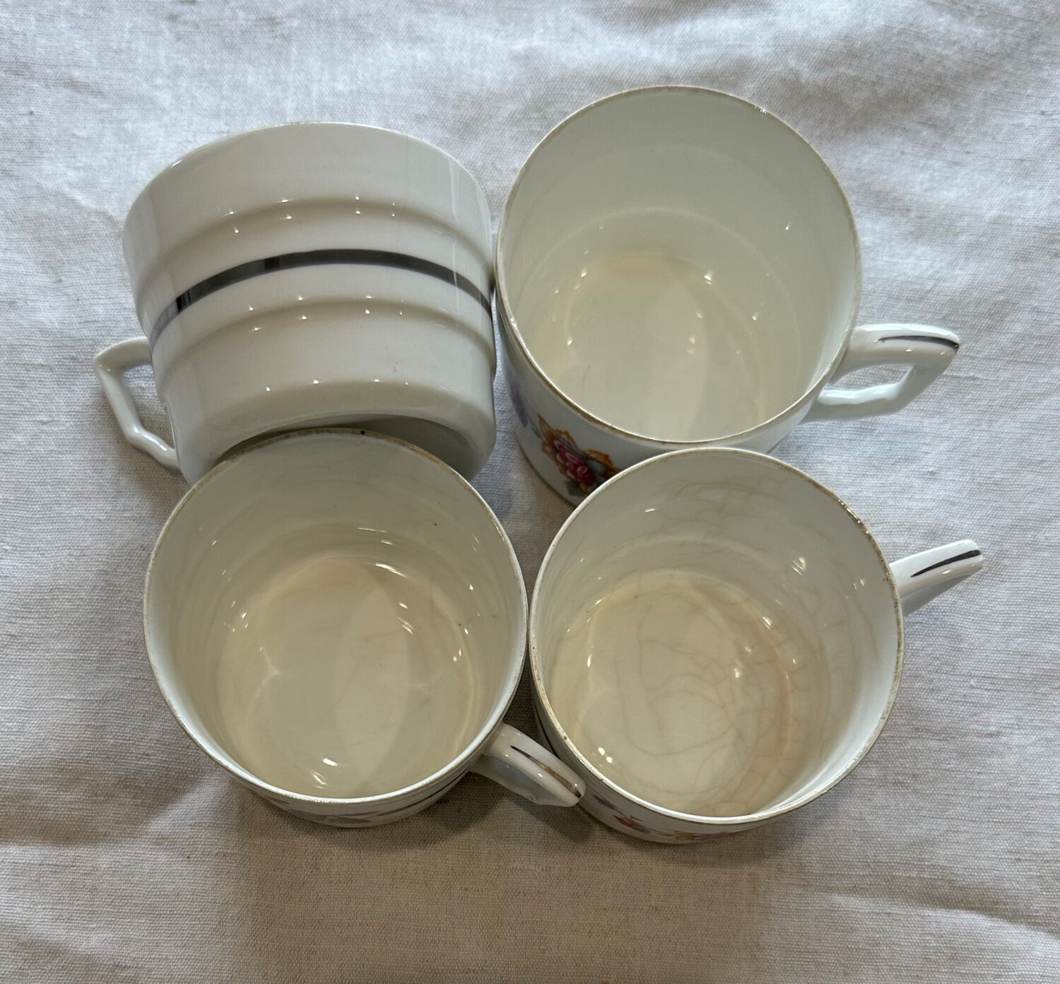 Set of 4 fine porcelain coffee cups with floral patterns and silver accents.