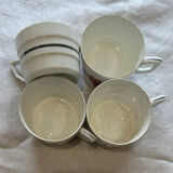 Set of 4 fine porcelain coffee cups with floral patterns and silver accents.