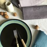 Set of four old damasked and monogrammed towels, tinted multiple colors