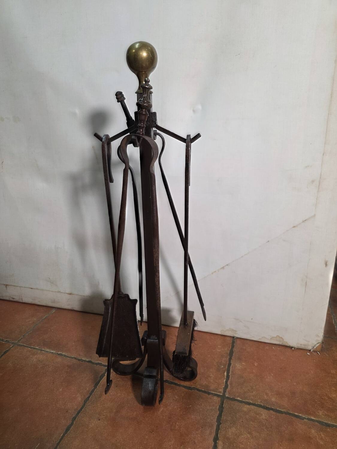 Antique fireplace set in solid wrought iron and brass.