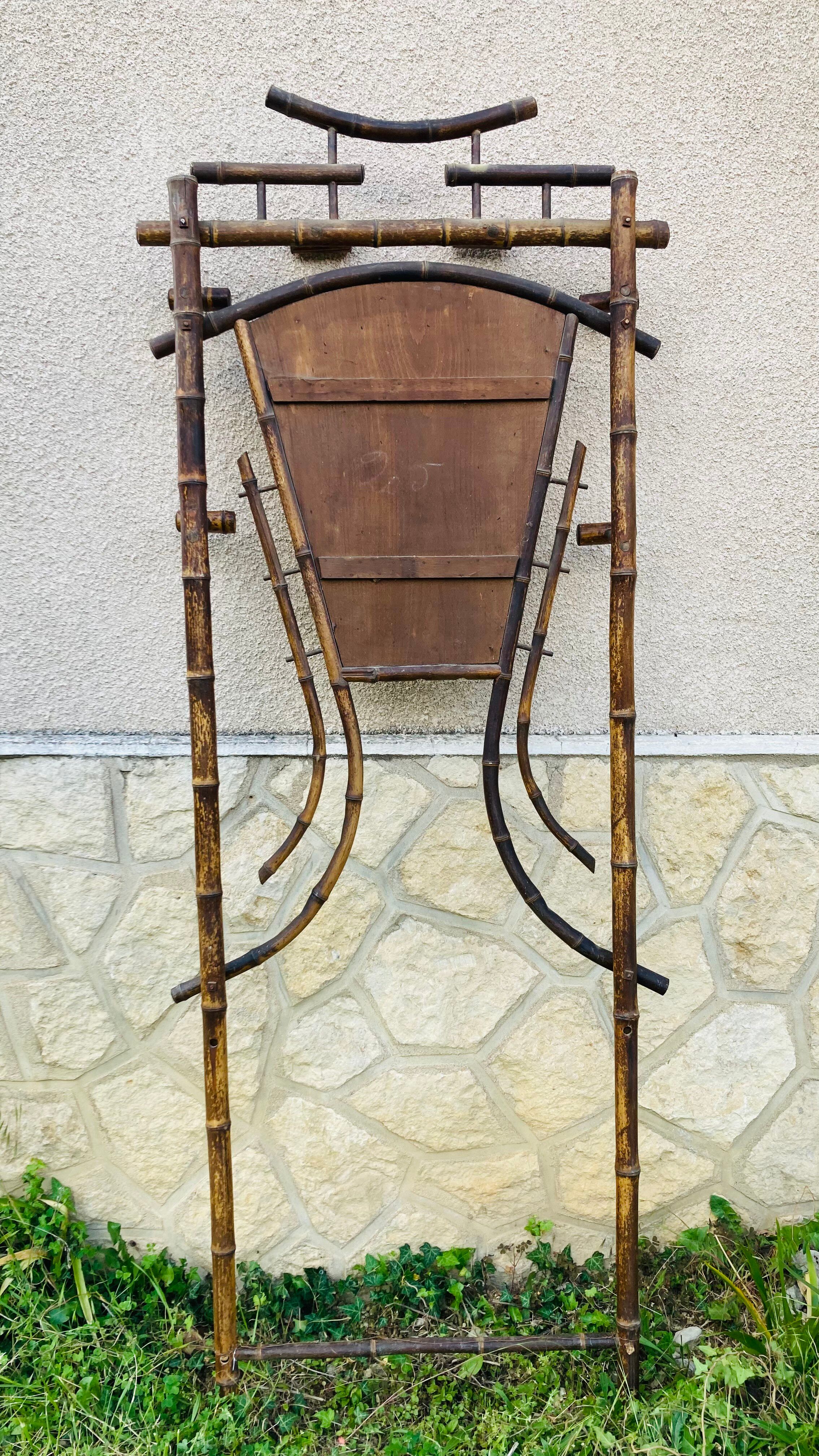 Bamboo coat rack from the 19th century, mirror in the shape of a crescent moon.
