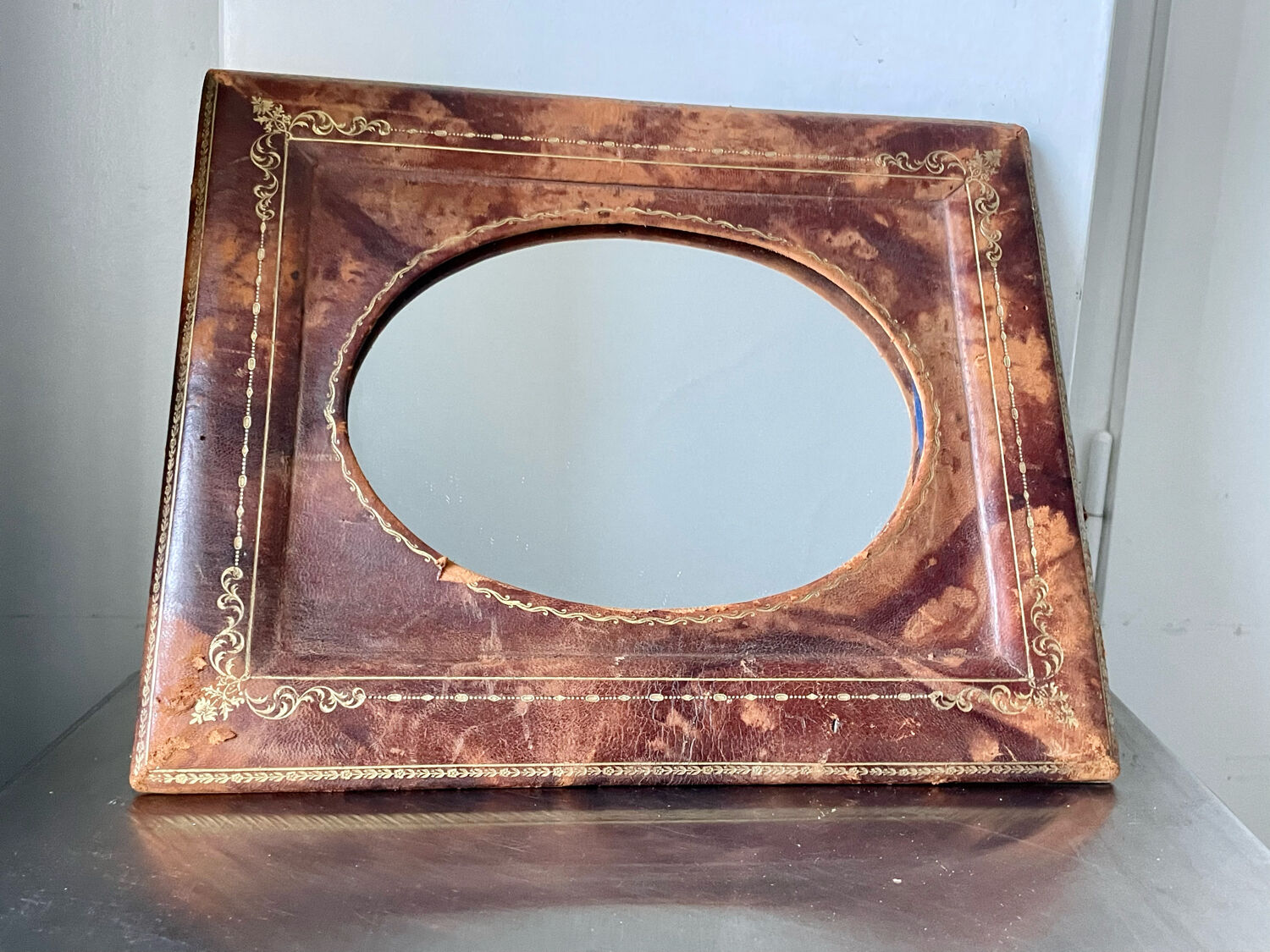 Antique leather framed mirror with gildings 30 cm x  24 cm