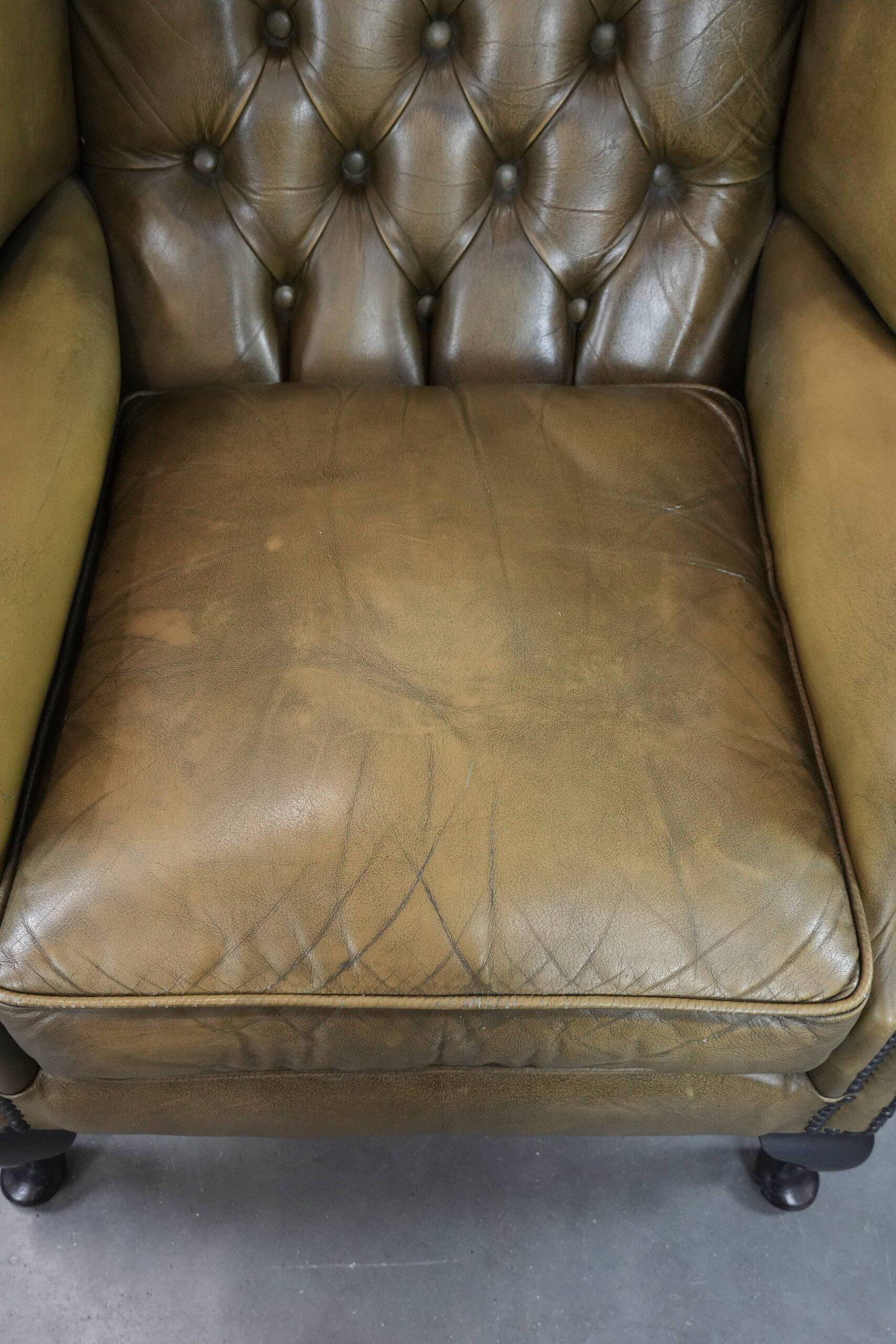 Moss green cow leather Chesterfield wingback armchair in English style