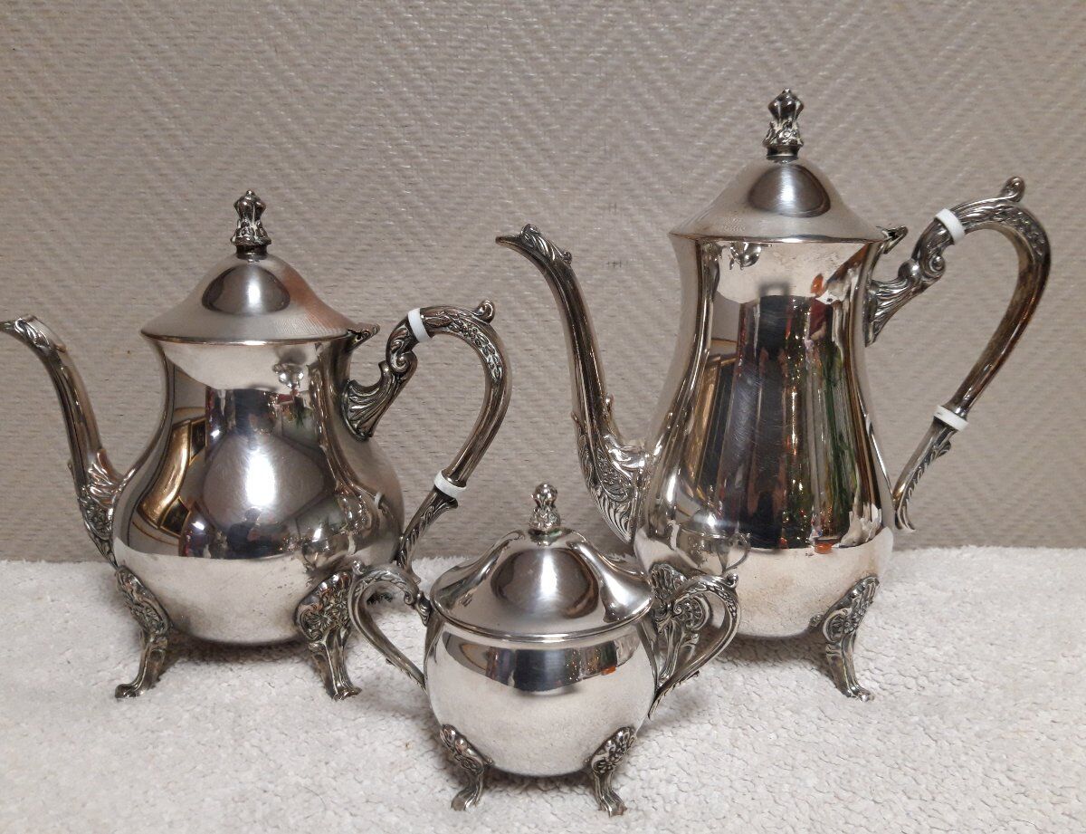 Silver-plated coffee and tea service including a coffee pot, a teapot, and a sugar bowl.
