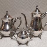 Silver-plated coffee and tea service including a coffee pot, a teapot, and a sugar bowl.