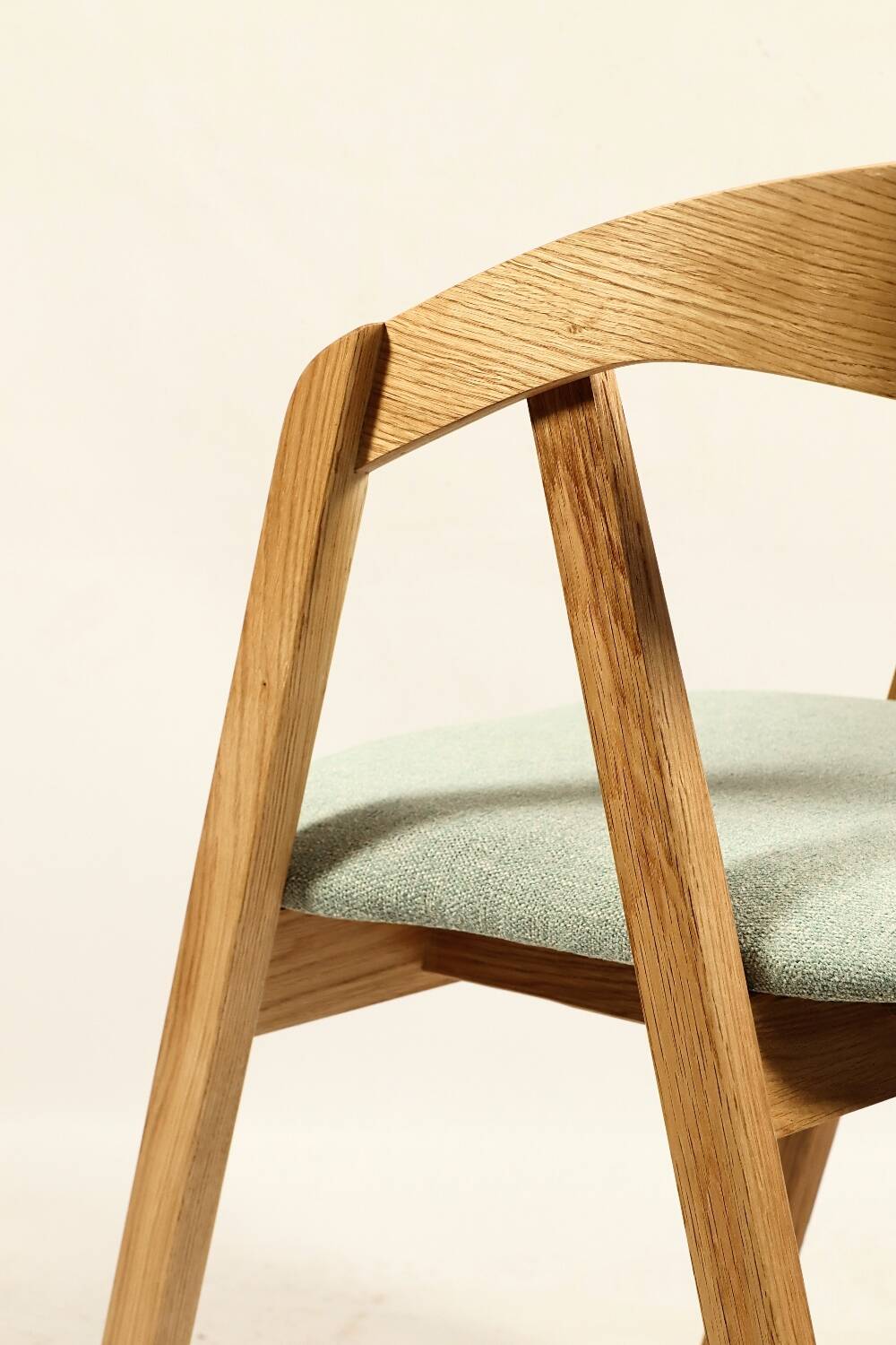 Vintage dining chair in light oak with natural linen pastel green fabric.
