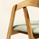Vintage dining chair in light oak with natural linen pastel green fabric.