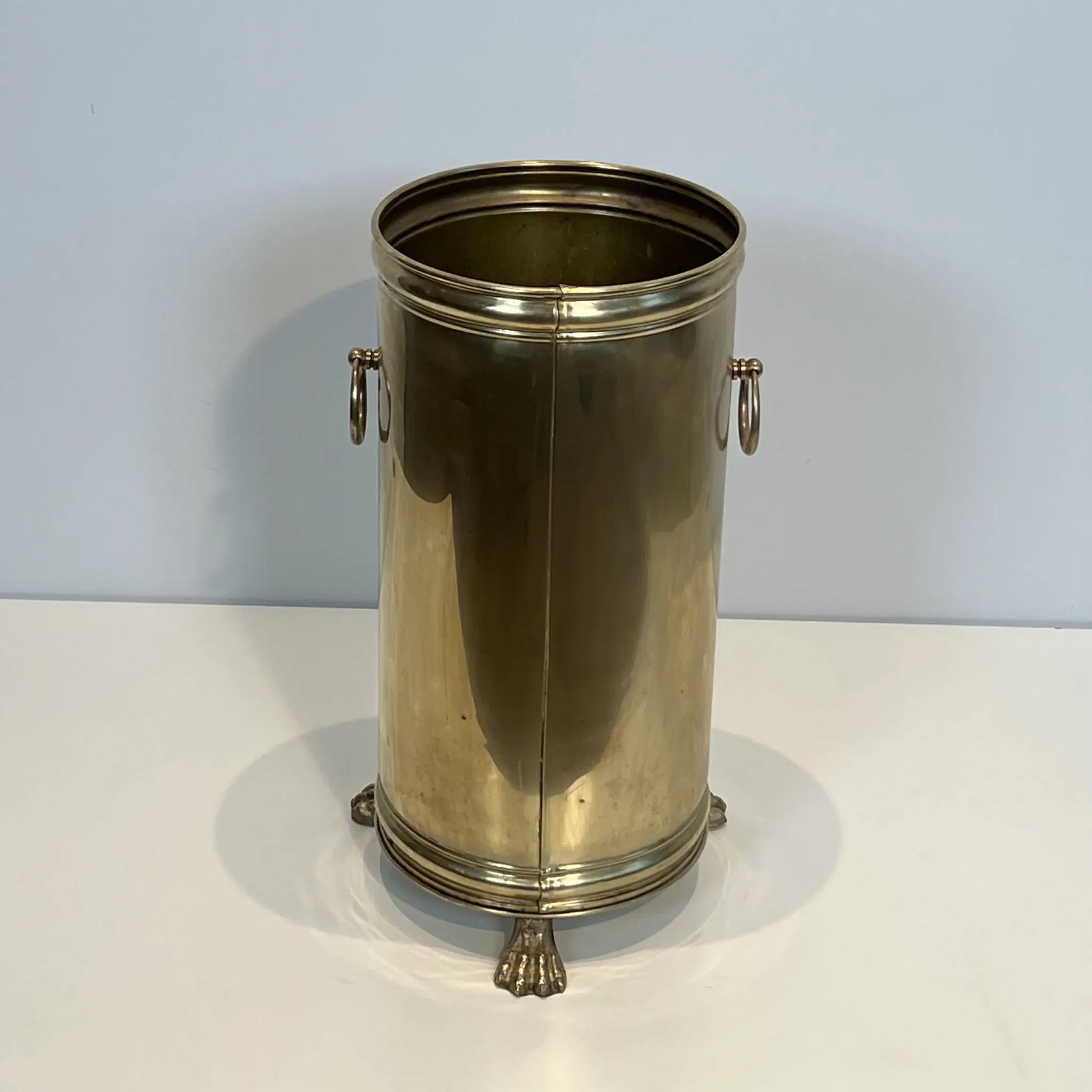 Cylindrical Brass Umbrella Stand with Ring Handles and Claw Feet.