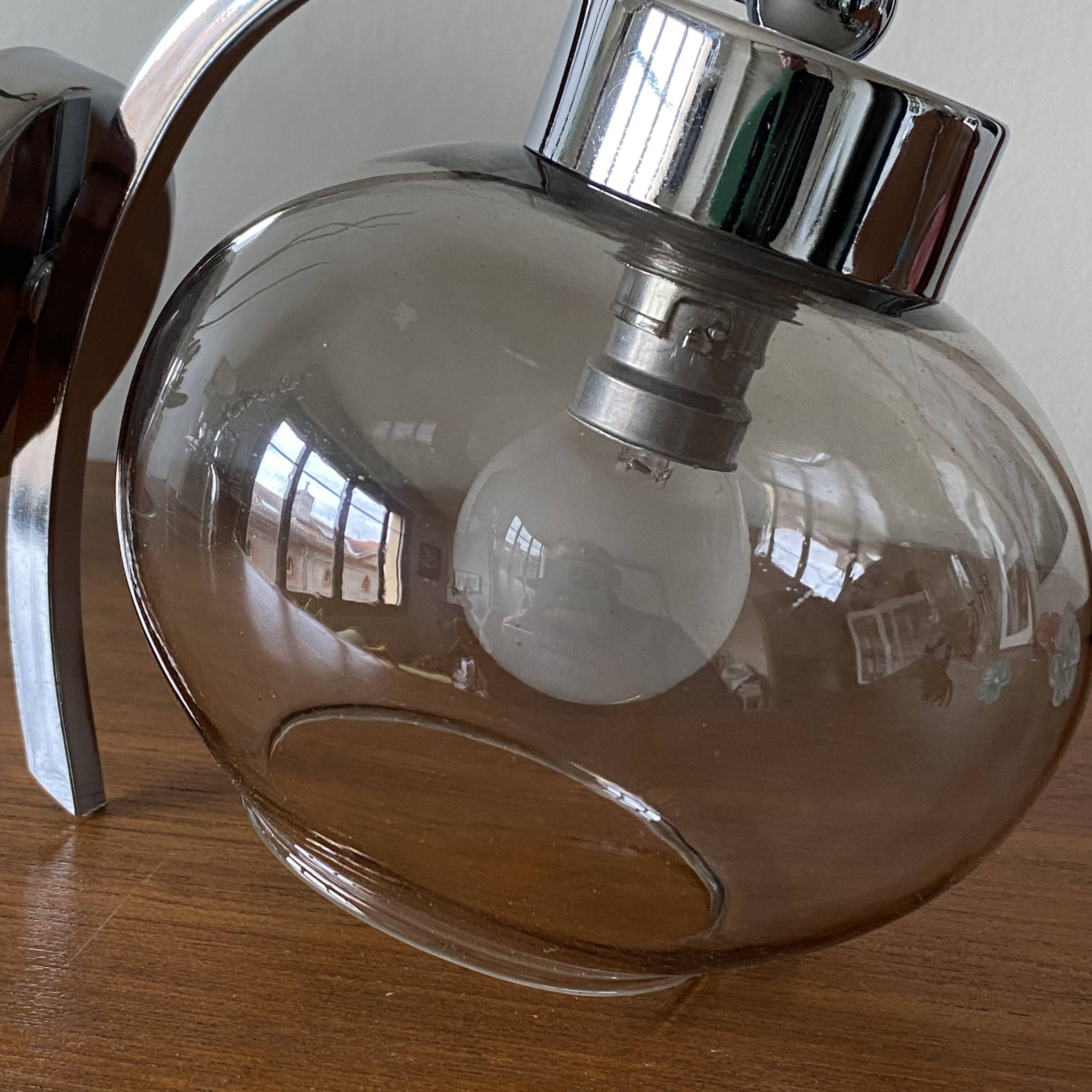 Wall light in chromed metal and smoked grey glass globe