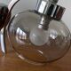 Wall light in chromed metal and smoked grey glass globe