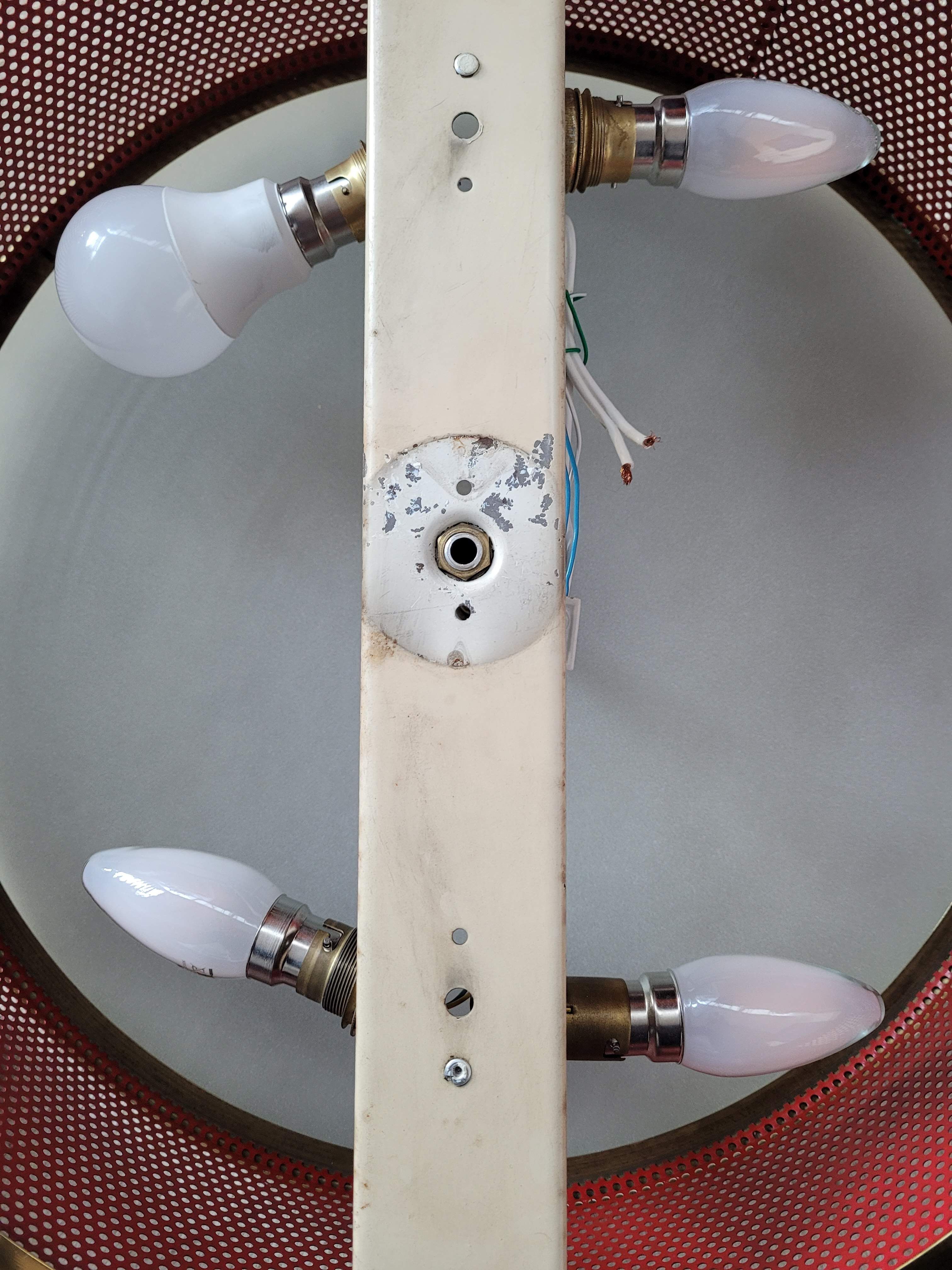 Ceiling lamp applied in red lacquered perforated metal