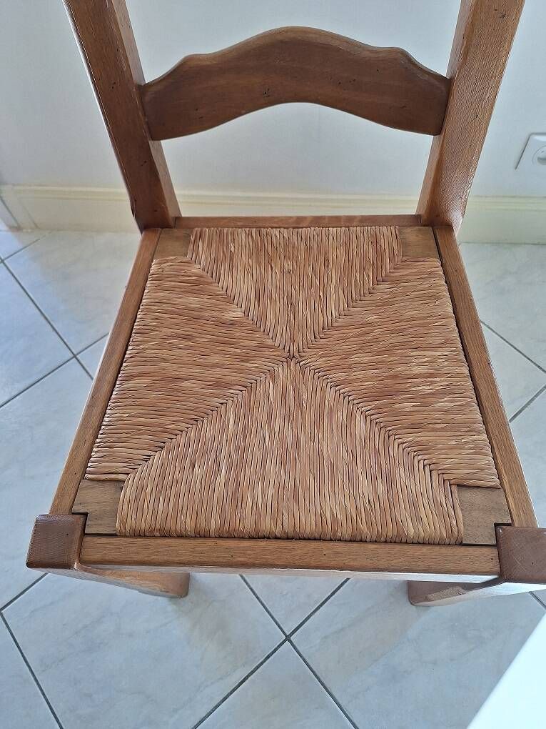Set of 6 solid oak chairs with straw seats.