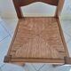 Set of 6 solid oak chairs with straw seats.