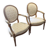 Pair of Louis XVI style armchairs, in solid walnut, re-edged and upholstered, pegged