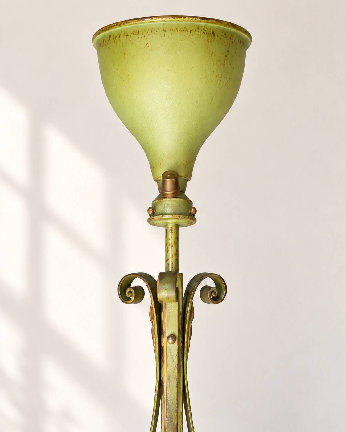 Antique green-painted iron floor lamp with a floral design.