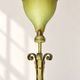 Antique green-painted iron floor lamp with a floral design.