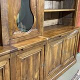 Library in walnut and oak from the early 20th century with its central clock.