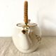 Vintage porcelain and rattan teapot