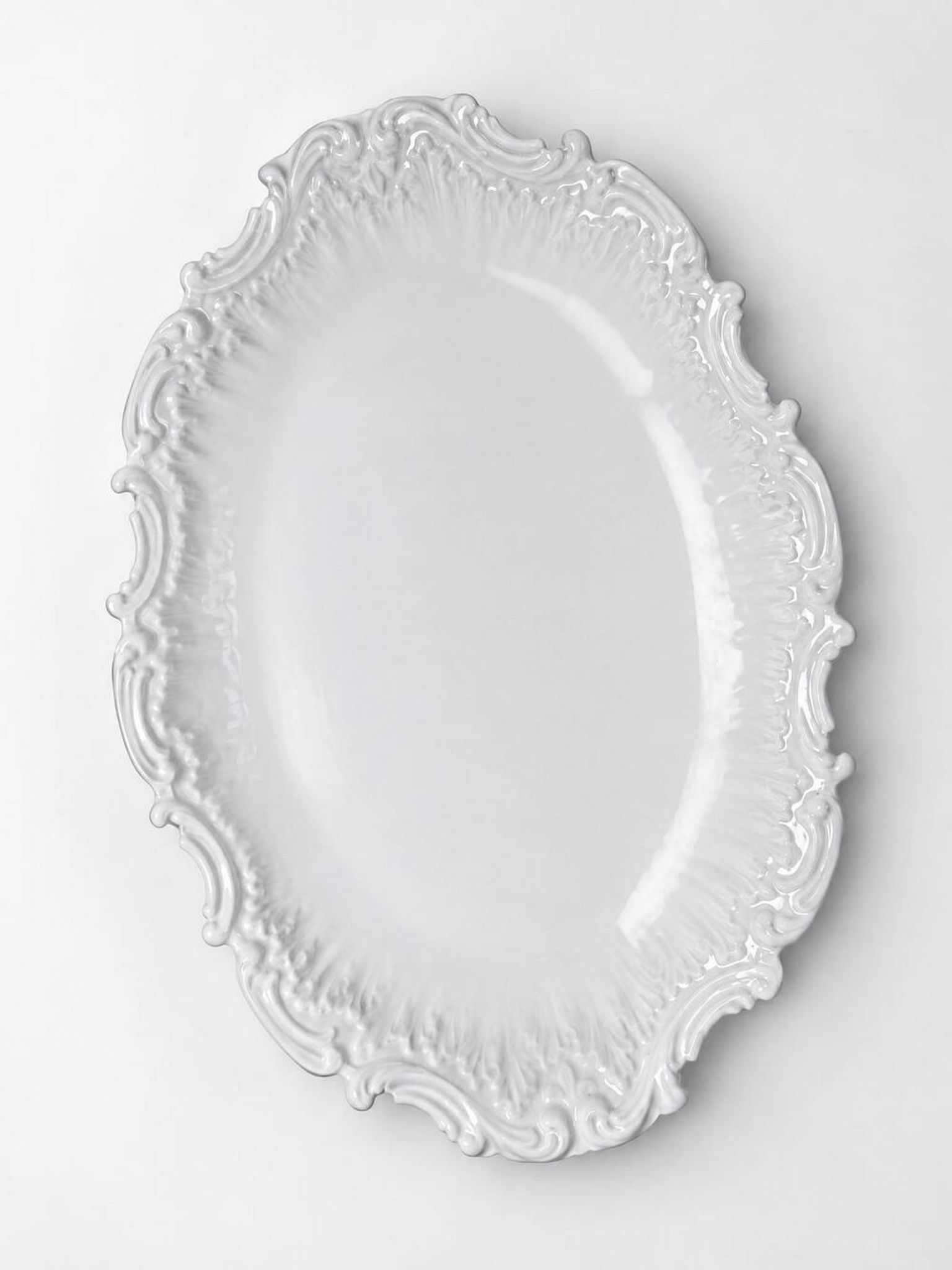 Antique deep dish in white Limoges porcelain, with rockwork relief.
