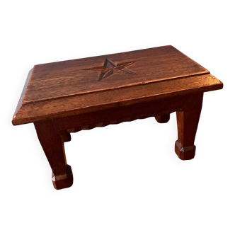 Small stool or footrest with sculpted decoration