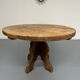 Round table in solid wood, thick top, vintage brutalist style from the 1960s.