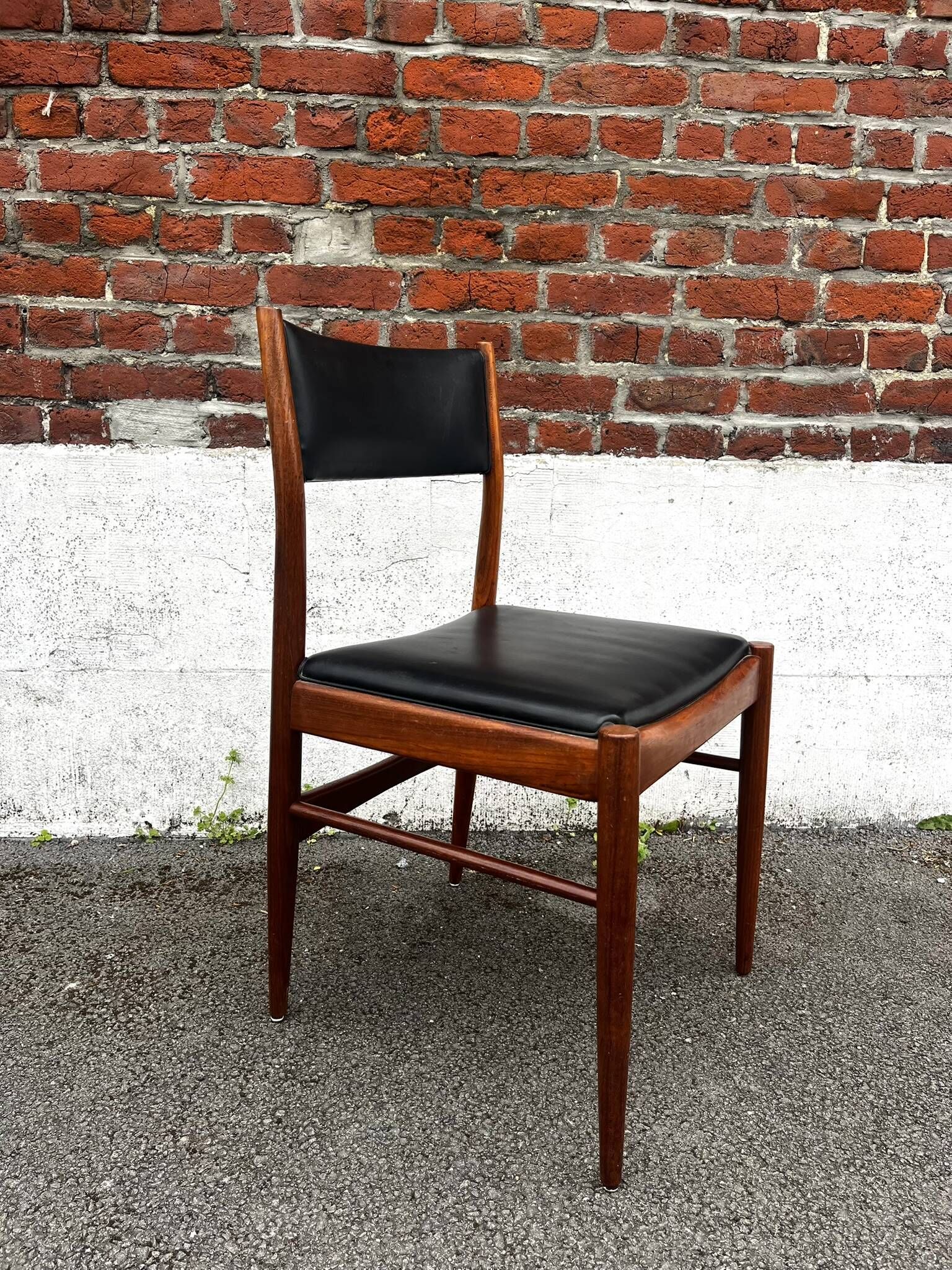 Set of 2 vintage Scandinavian chairs in wood and black faux leather.