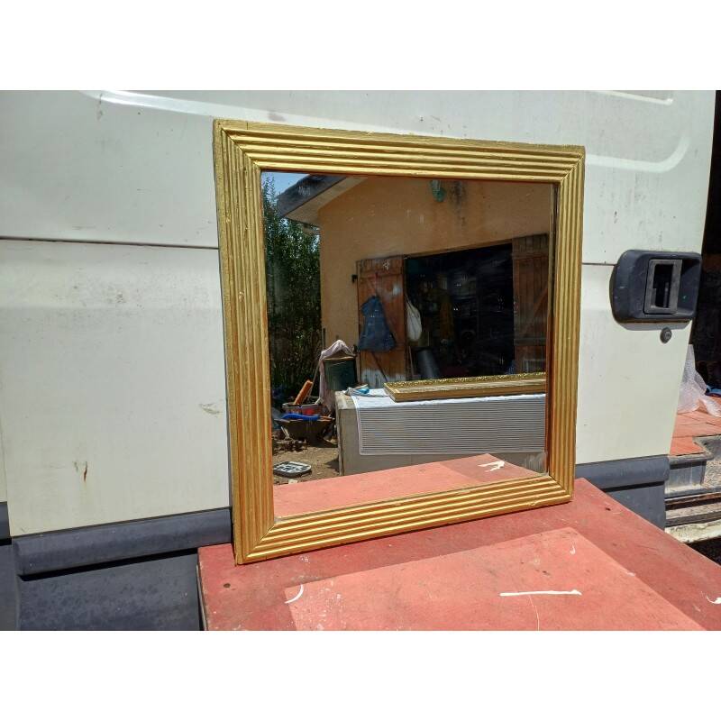 Wooden mirror and gold trim