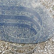 Oval coffee table of the 70s chromed metal base in s smoked glass top