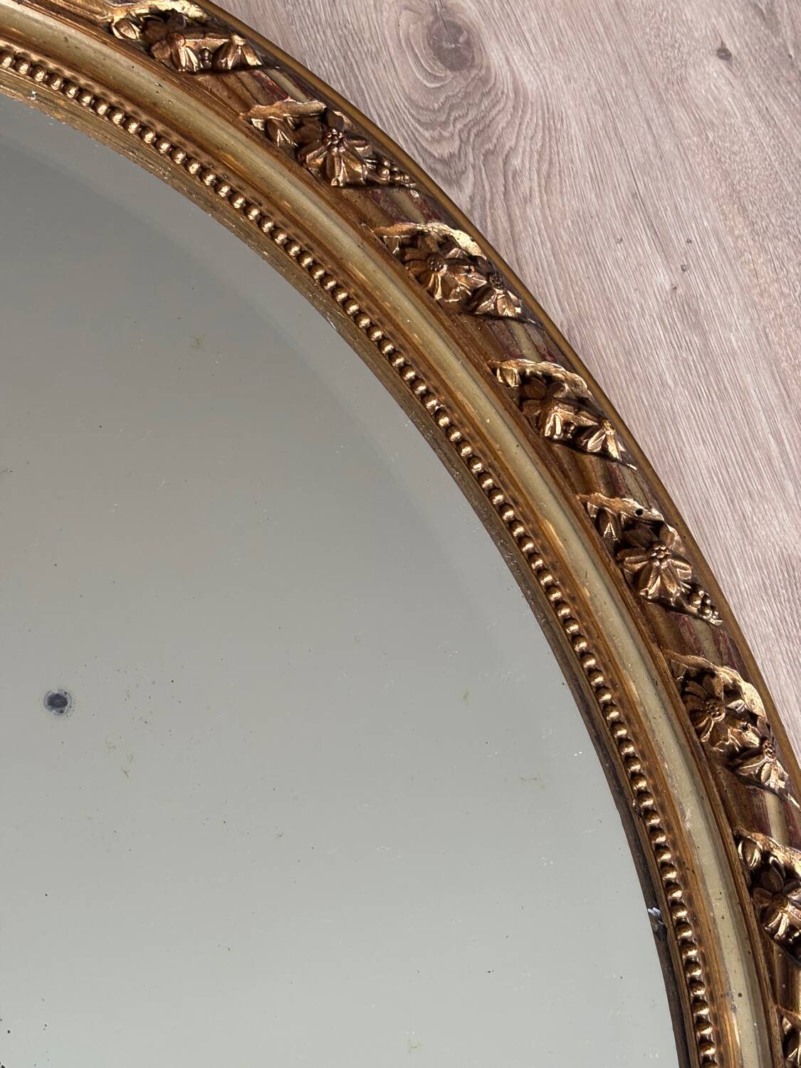 19th century oval gilded mirror, torch & quiver 106cm