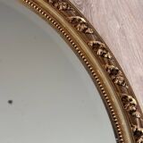 19th century oval gilded mirror, torch & quiver 106cm