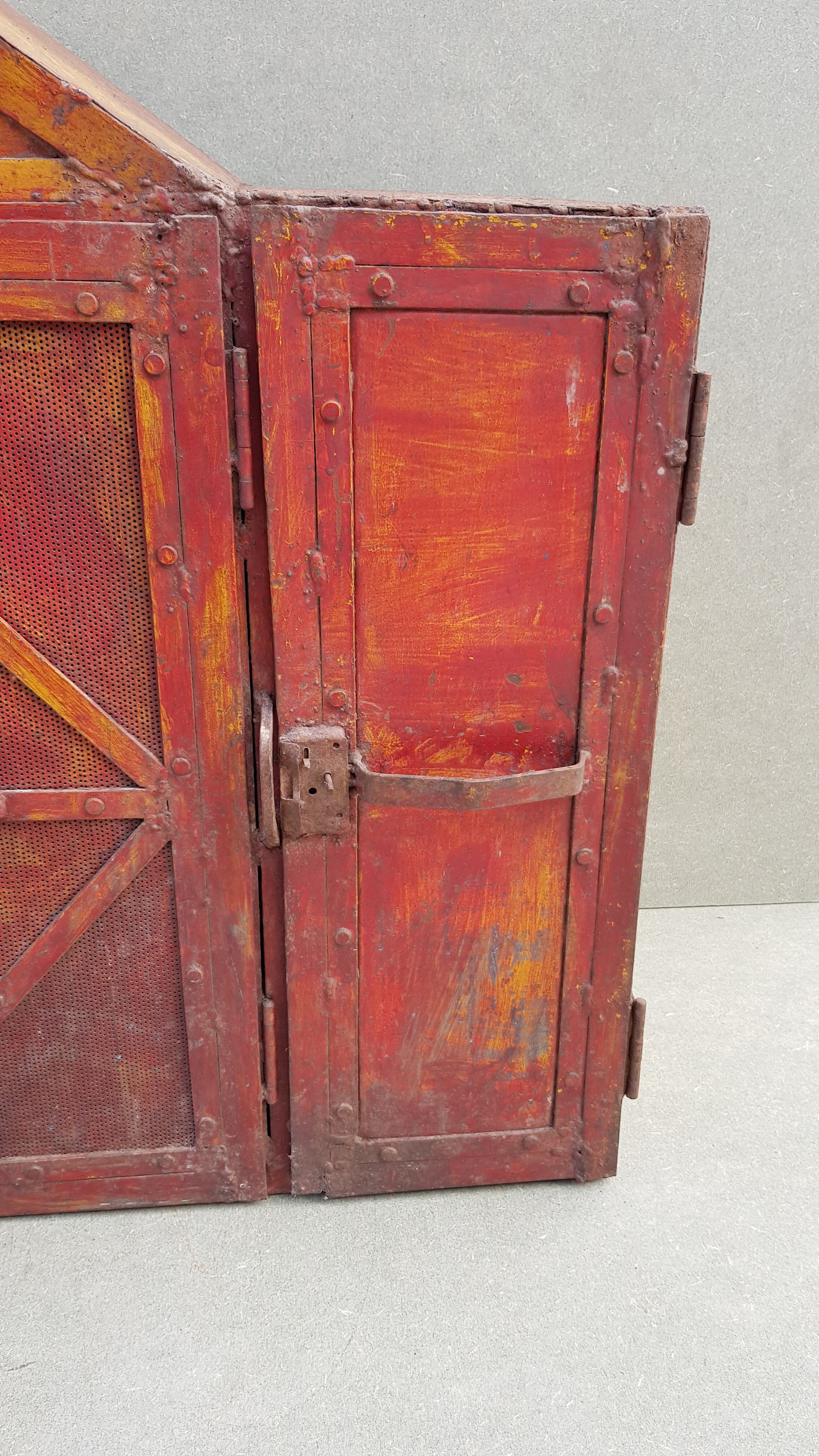 Old atypical metal workshop furniture with its original red patina