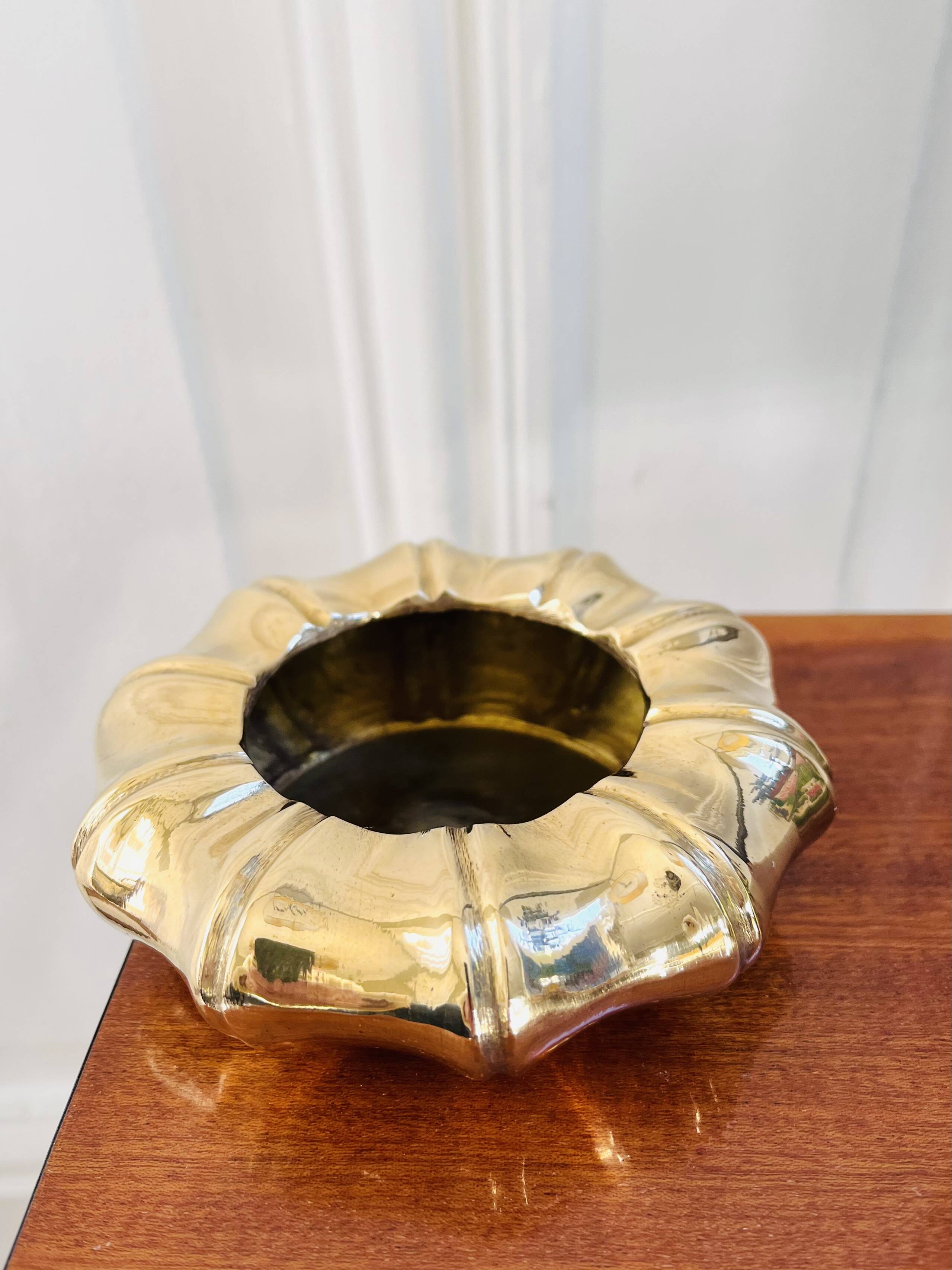 Golden brass ashtray with bamboo decoration.