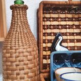 Green glass bottle and wickerwork