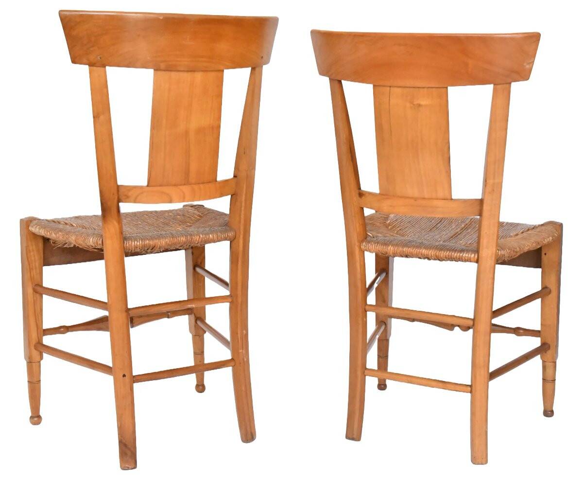 Pair of chairs with slatted backs and painted bands depicting animated landscapes.