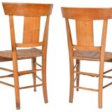 Pair of chairs with slatted backs and painted bands depicting animated landscapes.