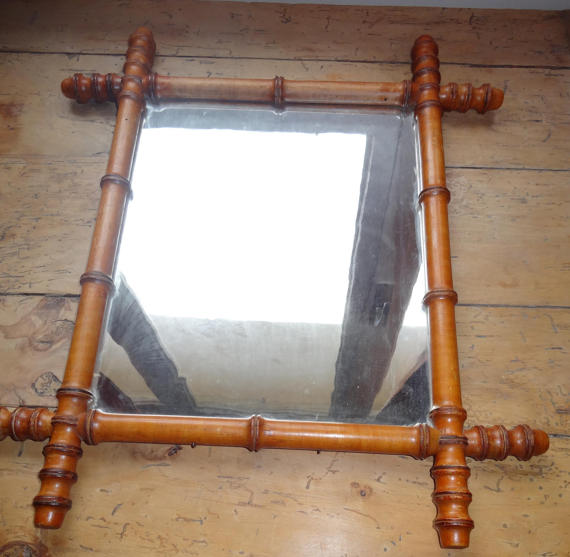 Mirror to the wooden frame imitating bamboo
