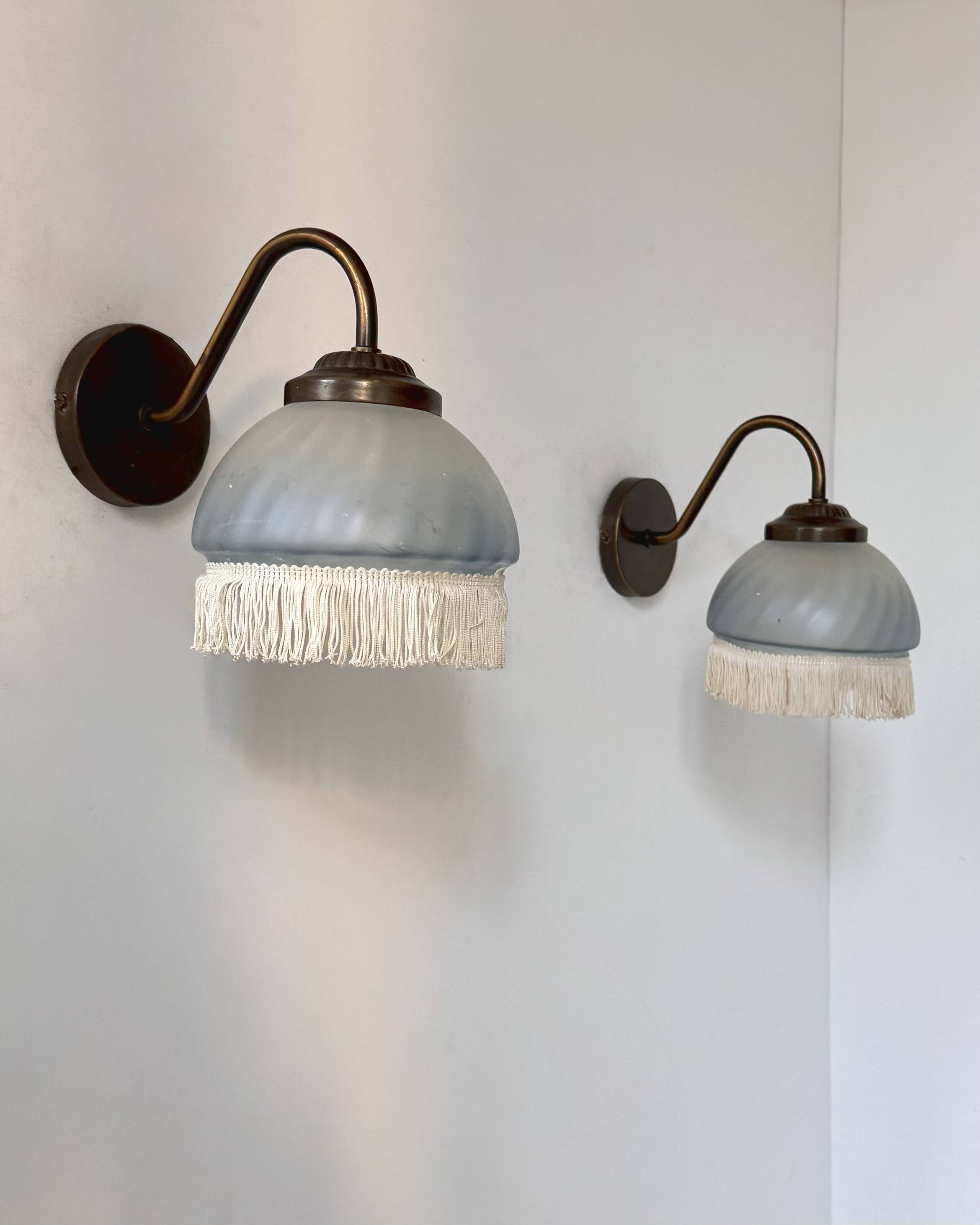 Pair of vintage wall lights in brass and blue-tinted glass, France 1970.