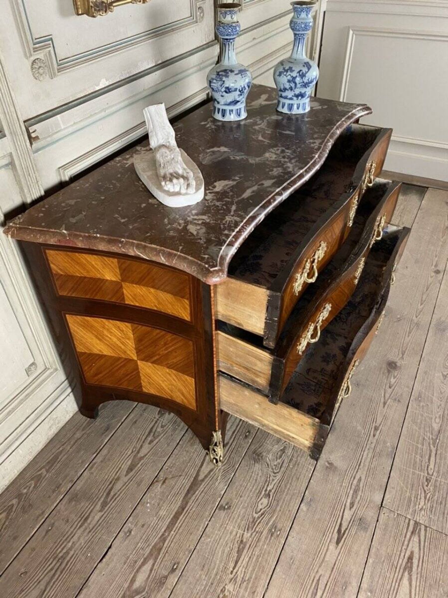Louis XV style commode in rosewood and palisander veneer, gilt bronze mounts, and Rance marble top.