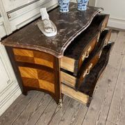 Louis XV style commode in rosewood and palisander veneer, gilt bronze mounts, and Rance marble top.